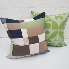 Load image into Gallery viewer, Two decorative pillows, one with a green leaf pattern and the other with a patchwork design, on a white background.
