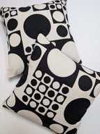 Two black and white patterned pillows on a light background