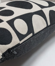 Load image into Gallery viewer, Close-up of a black and white patterned cushion on a light gray surface