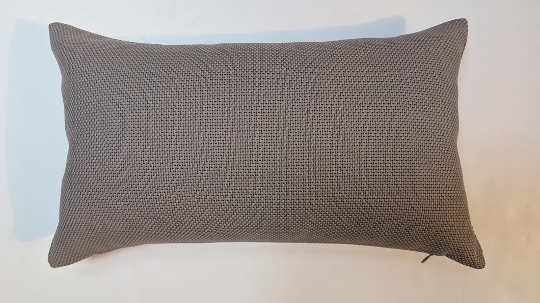 Textured gray pillow on a light blue and white background
